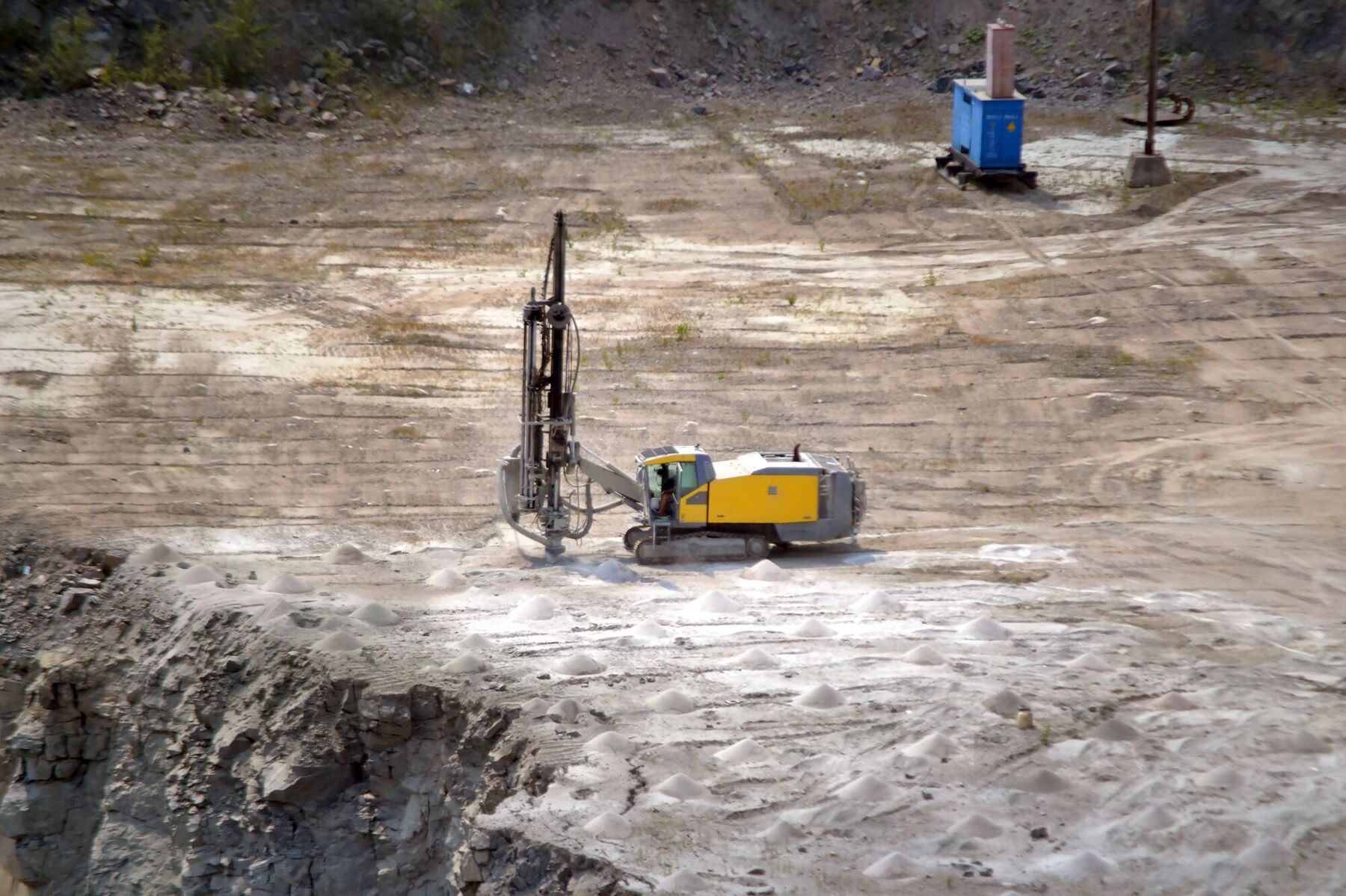 yellow-drill-machine-closeup-granite-quarry